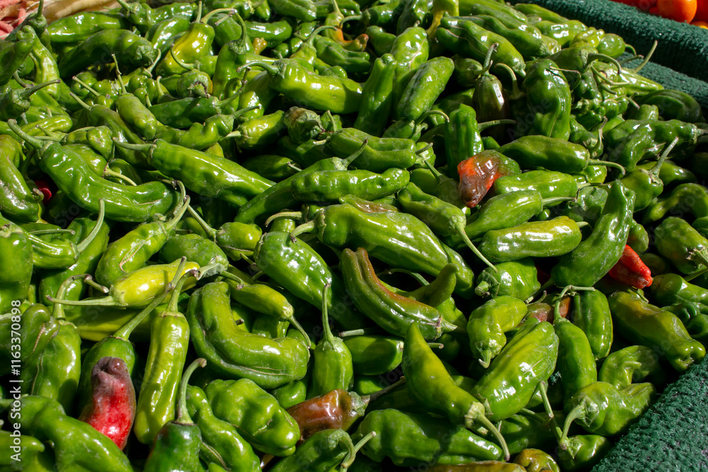 A view of a pile shishito peppers, on display at a local farmers market. A view of a pile shishito peppers, on display at a local farmers market.