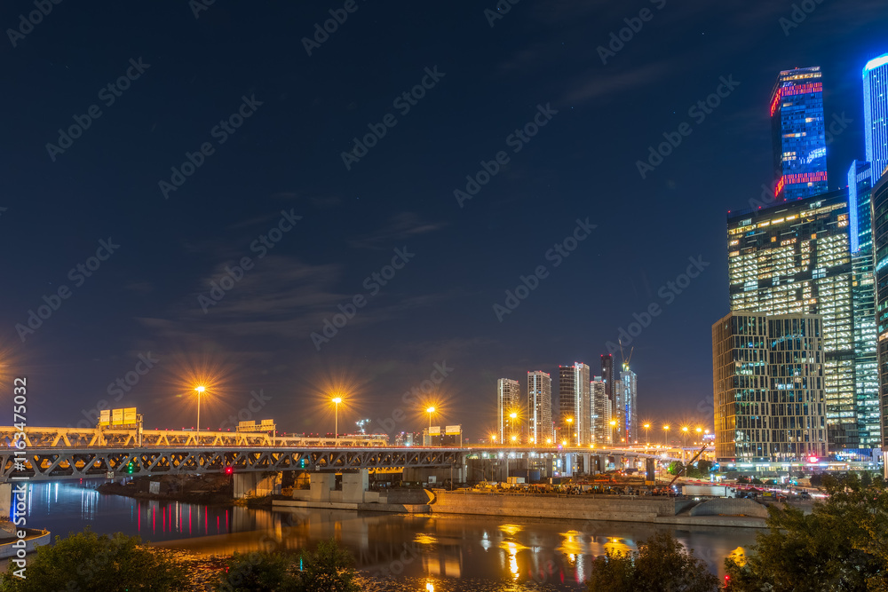 The scyscrapers of the Moscow City at night and the Dorogomilovsky bridge with illumination. Translation of text - street names: Krasnopresnenskaya, center, etc. The scyscrapers of the Moscow City at night and the Dorogomilovsky bridge with illumination. Translation of text - street names: Krasnopresnenskaya, center, etc.