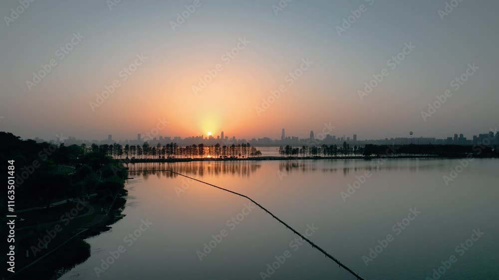 Stunning aerial view of Wuhan East Lake at sunset showcasing vibrant colors and tranquil waters Stunning aerial view of Wuhan East Lake at sunset showcasing vibrant colors and tranquil waters