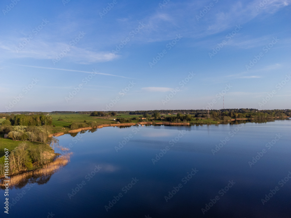 A serene island surrounded by calm blue water. Aerial view of a peaceful green island, tranquil mood, high-angle shot, rural countryside setting, concept of nature, and relaxation. A serene island surrounded by calm blue water. Aerial view of a peaceful green island, tranquil mood, high-angle shot, rural countryside setting, concept of nature, and relaxation.