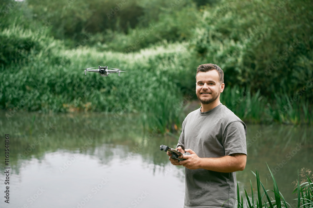 Man operating drone using handheld remote. Man operating drone using handheld remote.