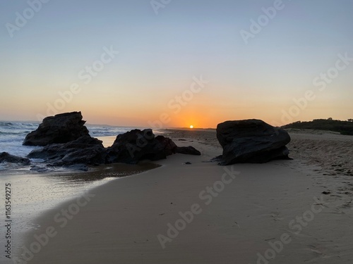sunset on the beach with rocks