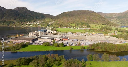 Industrial factory in Aardal, Stavanger, specializing in production of sand roofing tiles, Norway. Aerial forward photo