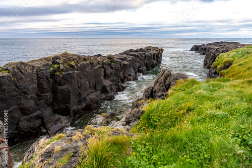 Vatnsnes peninsula, situated on the east coast of Iceland, boasts rocky cliffs overlooking the ocean photo