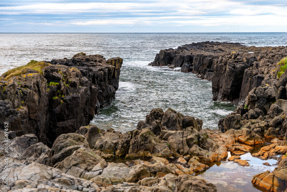 Iceland’s Vatnsnes peninsula is known for its rugged rocky cliffs along the eastern coastline Iceland’s Vatnsnes peninsula is known for its rugged rocky cliffs along the eastern coastline