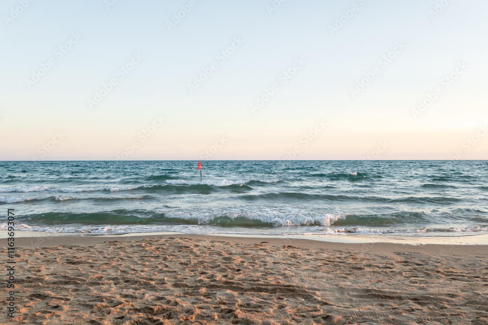 Red flag warning at the sea with high tide waves as signal for danger and hazard rip current activity in Thailand. Red flag warning at the sea with high tide waves as signal for danger and hazard rip current activity in Thailand.