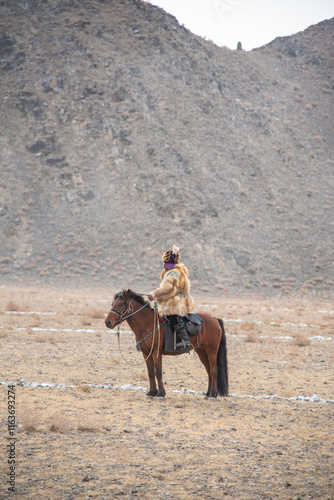 Traditional Mongolian Eagle Festival featuring a Kazakh eagle hunter and his trained golden eagle, celebrating the ancient tradition of eagle hunting in western Mongolia.