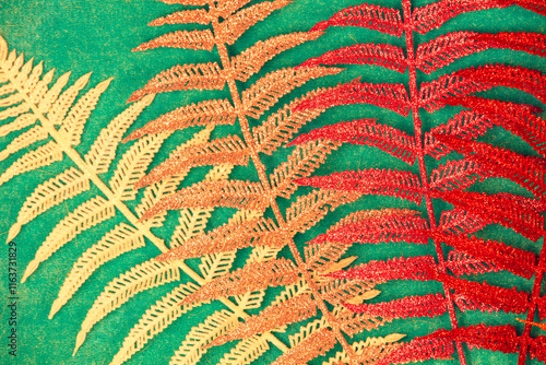 Obraz na płótnie Colorful artificial fern leaves on a green background w salonie