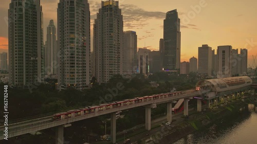 Wallpaper Mural Pull-back drone shot of the trains moving at Dukuh Atas LRT Station at sunset in Jakarta, Indonesia Torontodigital.ca