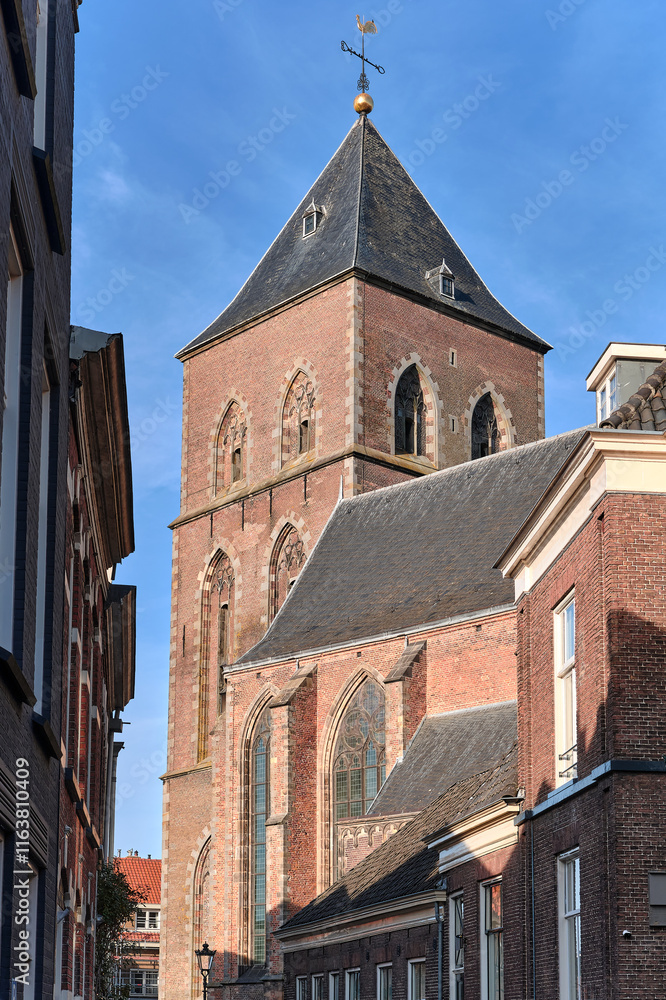 Brick tower of Onze Lieve Vrouwenkerk church in Kampen , The Netherlands, against blue sky Brick tower of Onze Lieve Vrouwenkerk church in Kampen , The Netherlands, against blue sky
