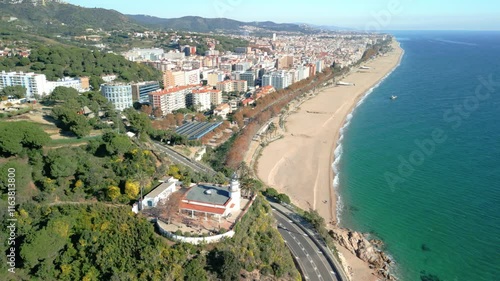 Wallpaper Mural Aerial view with Drone, of Calella de Mar on the coast of Maresme, Spain, flight over the main beach and the lighthouse Torontodigital.ca