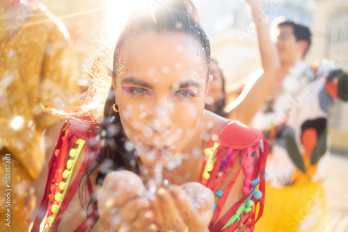 Confetti blow in the street of happy Carnival party. Brazil traditional festival abstract blurred background..