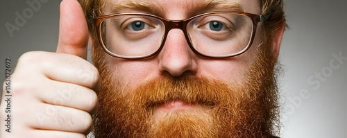 Redhead Man with Glasses Giving Thumbs Up: Positive, Approving, Cheerful, and Upbeat.