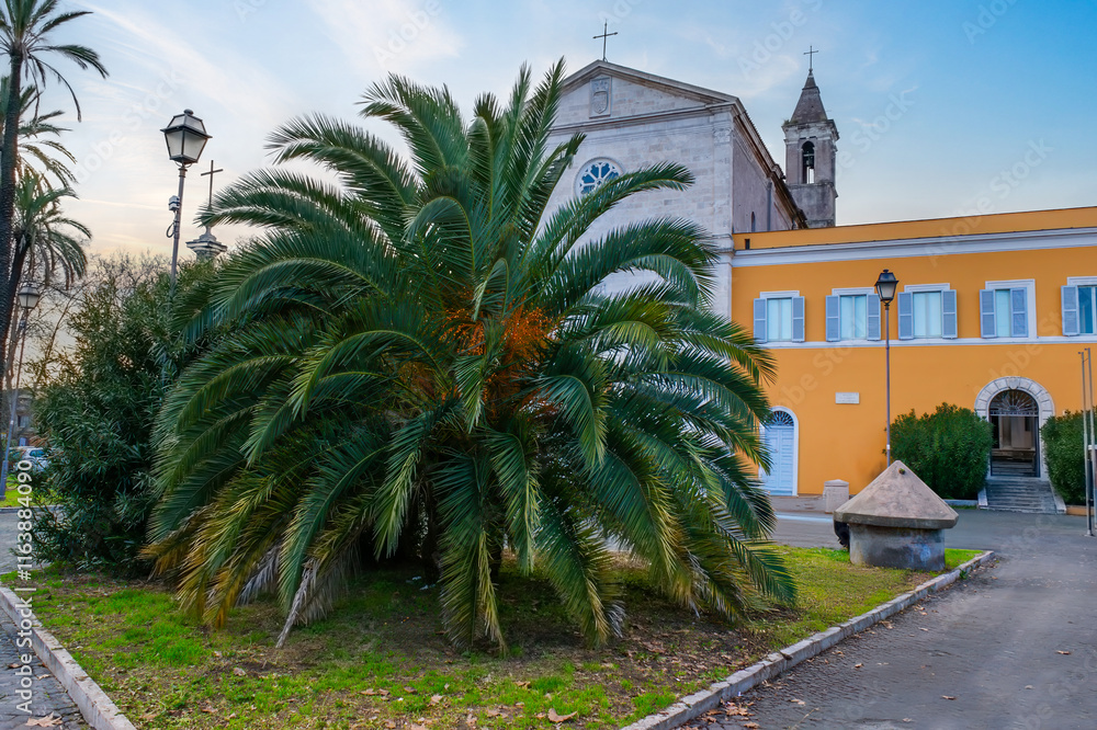 Saint Peter’s Church on the Golden Mountain with a palm tree in front, Rome, Italy