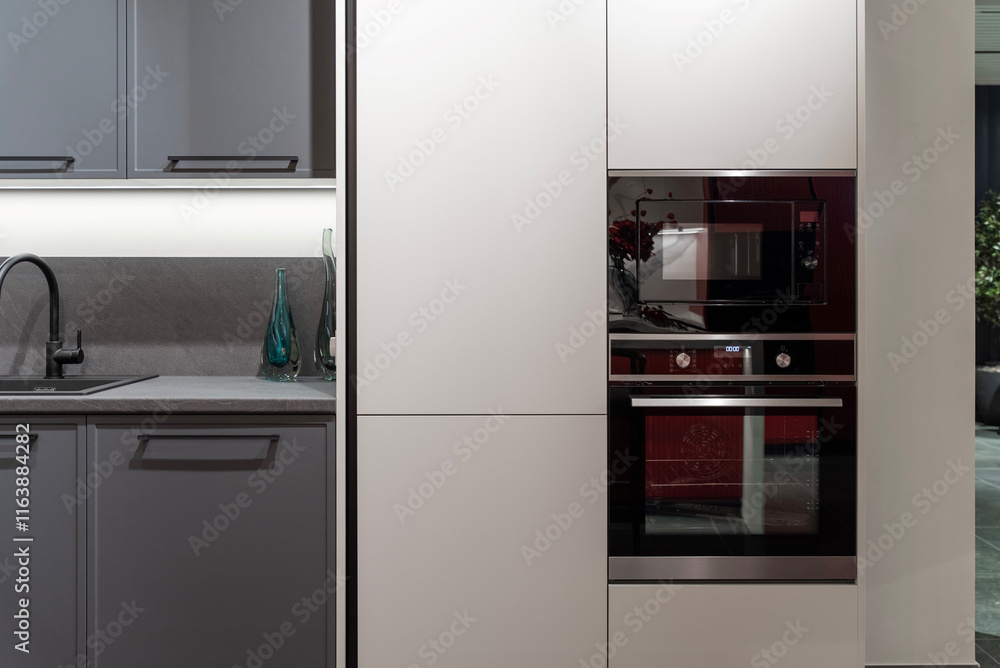 Fototapeta premium Black built-in microwave and oven with a seamless finish