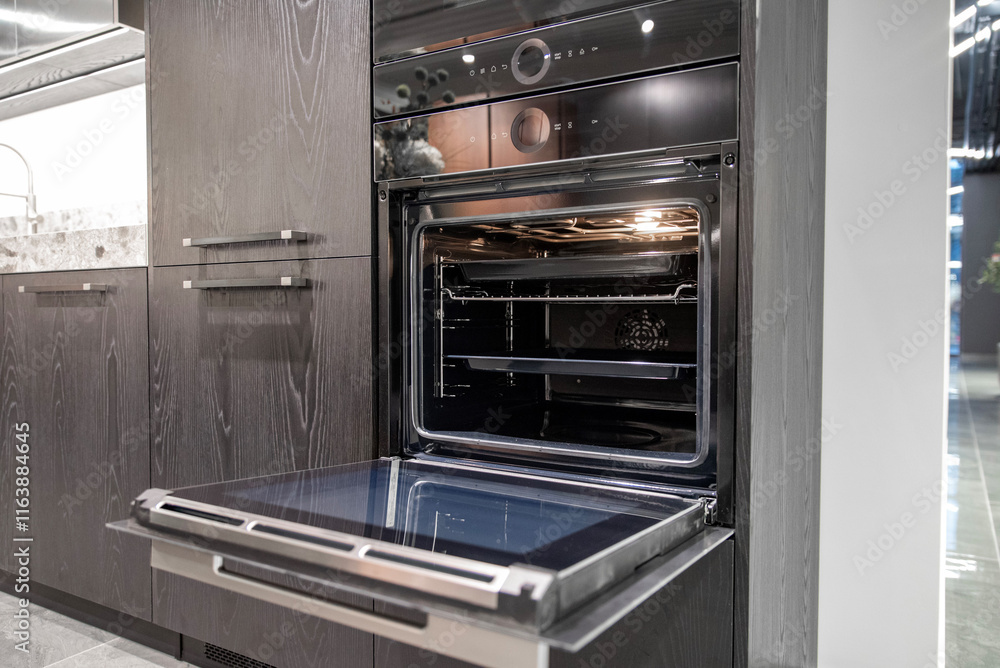 Modern black opened built-in oven in wooden kitchen cabinet Modern black opened built-in oven in wooden kitchen cabinet