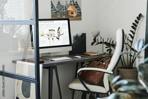 Wind turbine plan on desktop screen in modern office photo