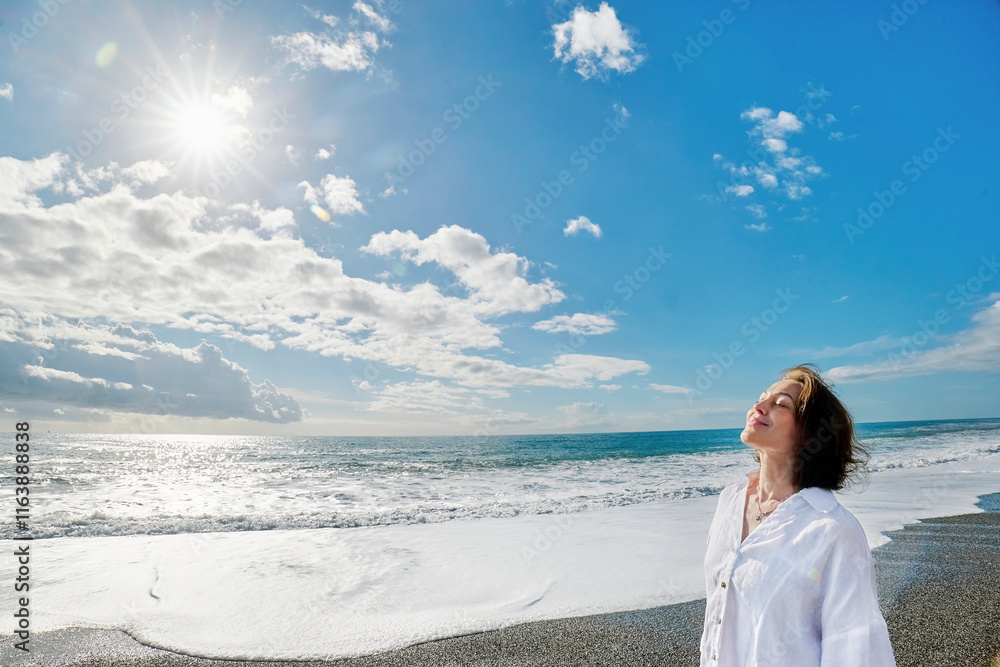 Smiling woman with eyes closed on beach at sunny day Smiling woman with eyes closed on beach at sunny day