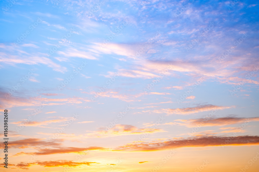 Obraz premium Sky,sunset, beautiful , luxury soft gradient orange gold clouds and sunlight on the blue sky perfect for the background, Sunrise on morning or everning in winter warm time ,Twilight summer,silhouette