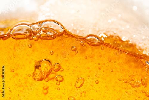 Close up bright orange Oil or beer splash texture and nature waves, Beautiful waves curve and little bubbles smooth for graphic design and background, Oil Bubbles, Soft beer bubbles, Selective focus photo