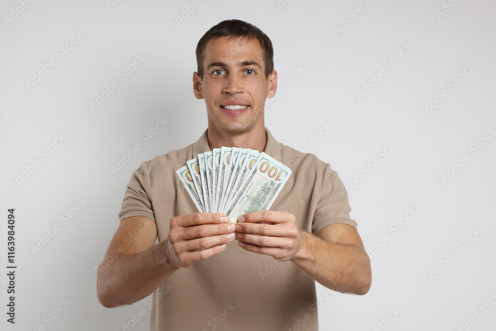 Man with dollar banknotes on white background Man with dollar banknotes on white background