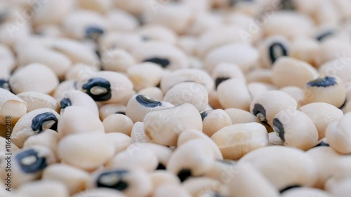 Heap of dried uncooked black eyed peas (borulce), slider shot. Depth of field, selective focus. Cooking, legumes, healthy eating, food preparation concepts. 4k photo