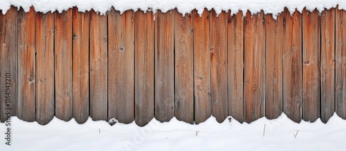 Wooden fence blanketed with fresh snow creating a serene winter landscape atmosphere