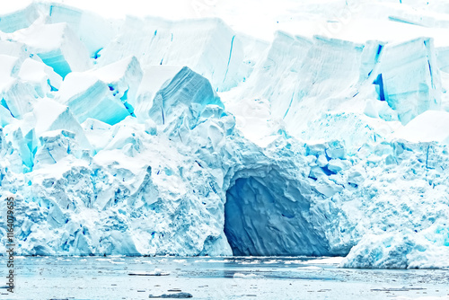 Beautiful glacier with an ice cave at it's base at Skontorp Cove on the Antarctic peninsula. The shades of white and blue due to different densities of ice. photo