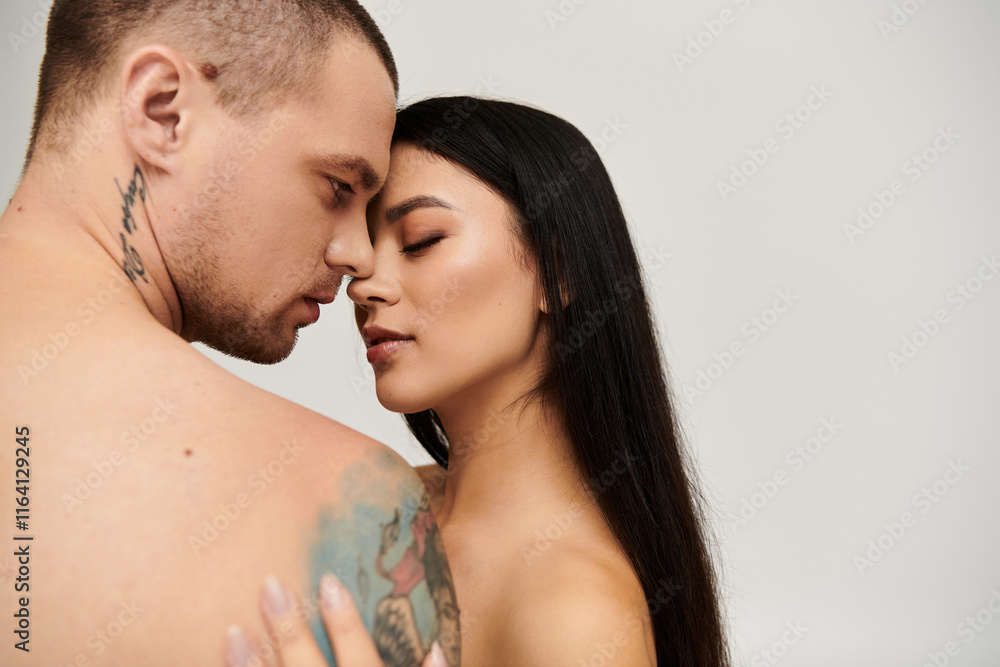 A seductive embrace captures the passion of a couple celebrating love in a studio setting. A seductive embrace captures the passion of a couple celebrating love in a studio setting.