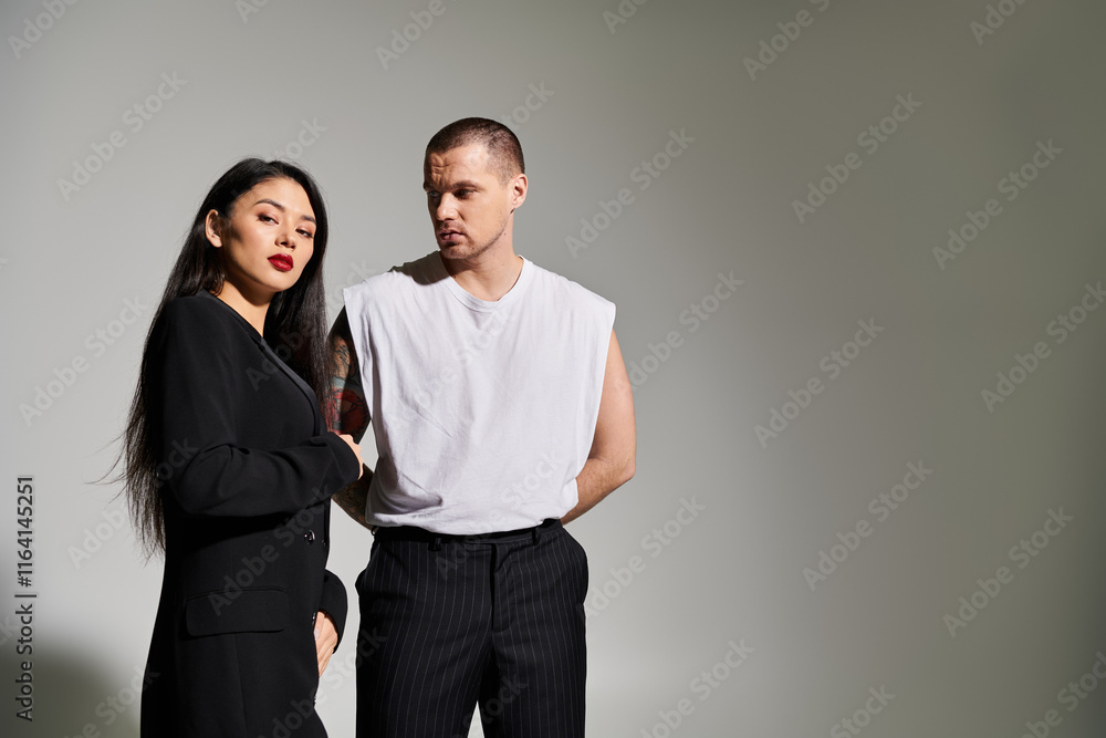 A beautiful couple showcases their romance in stylish outfits, celebrating love in a studio. A beautiful couple showcases their romance in stylish outfits, celebrating love in a studio.