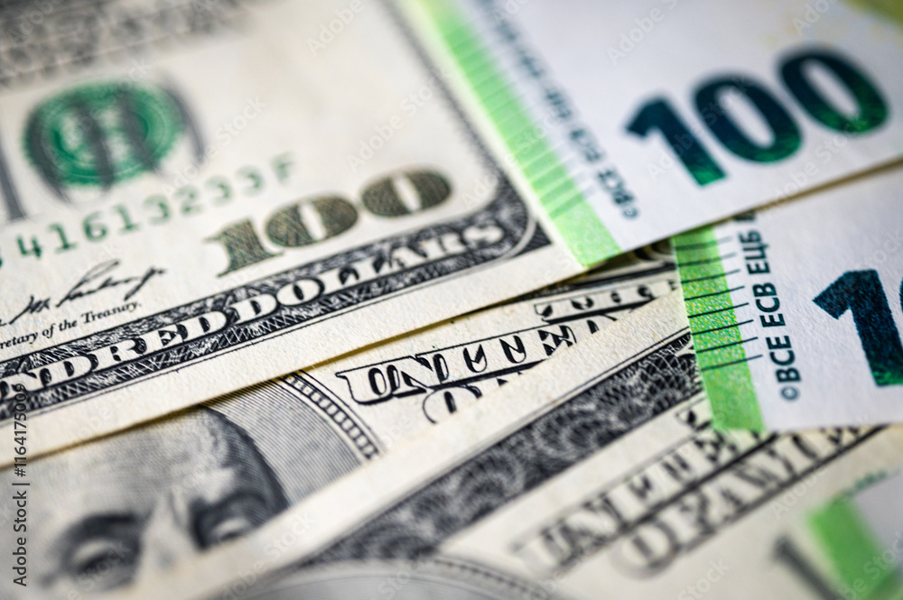 100 dollar bills and 100 euro bills close-up symbolize wealth, international finance, currency exchange and world economy, world currency market, competitors 100 dollar bills and 100 euro bills close-up symbolize wealth, international finance, currency exchange and world economy, world currency market, competitors