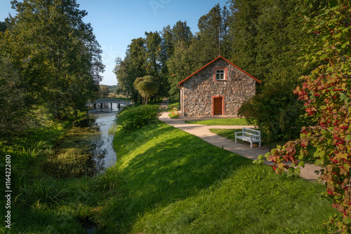 A traditional stone barn for storing flax on the shore of the pond 