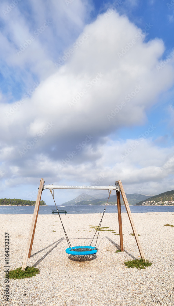 Swing on a rocky beach.