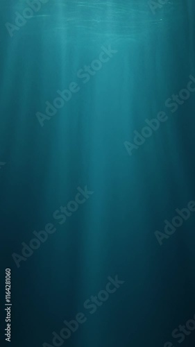 Vertical slow-motion footage of underwater god rays piercing the ocean surface, with enchanting beams of light flickering. Ideal VFX background for diving, snorkeling, and summer adventures
