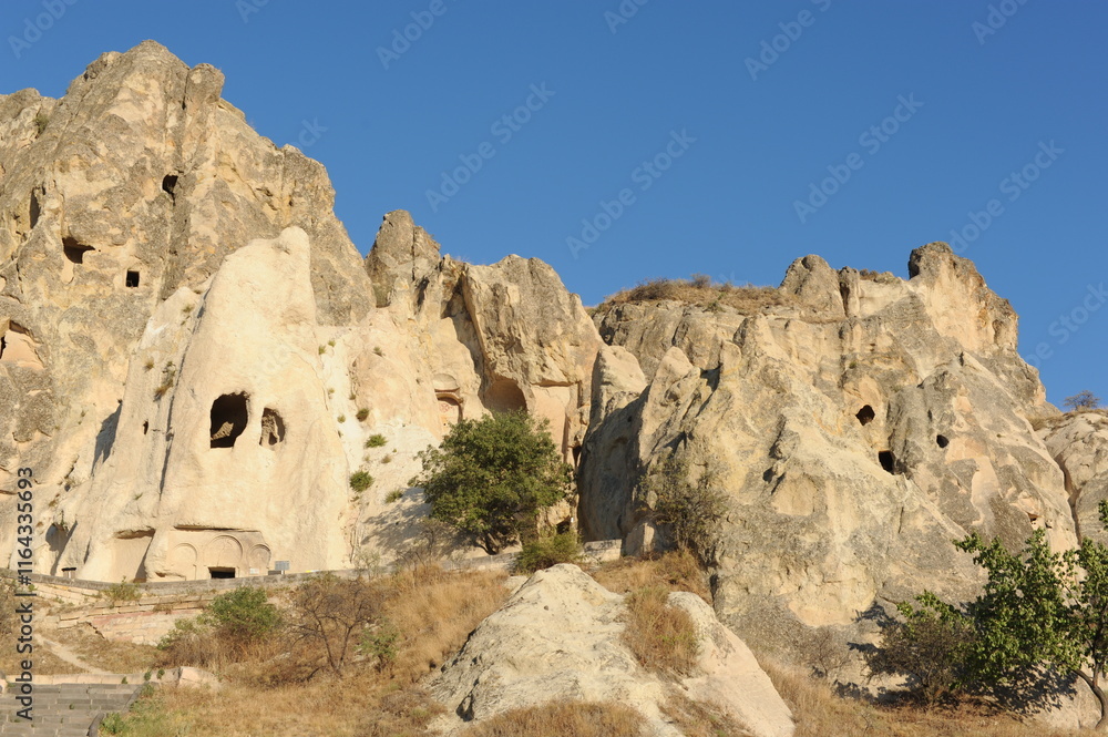 Rock formations with caves on a sunny day in Cappadocia, Anatolia, eastern Turkey Rock formations with caves on a sunny day in Cappadocia, Anatolia, eastern Turkey
