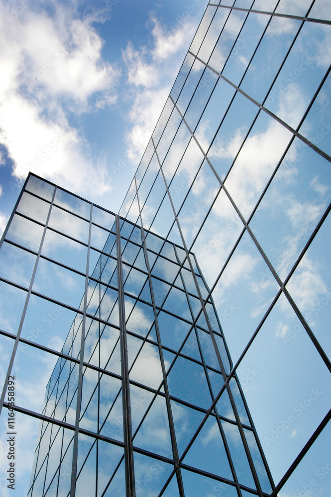 Glass Building for Business Reflection of Blue Sky and Clouds Glass Building for Business Reflection of Blue Sky and Clouds