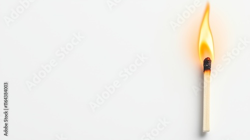 Lighted match igniting against a white background showcasing the flickering flame and burning tip