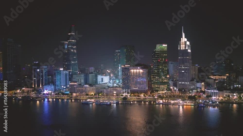 Wallpaper Mural A city skyline at night with a river running through it. The city is lit up with lights and the water is reflecting the lights Torontodigital.ca
