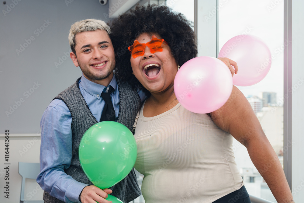 portrait of friends with birthday balloons smiling in office. portrait of friends with birthday balloons smiling in office.