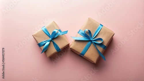 Wallpaper Mural Two presents wrapped in kraft paper with light blue ribbon bows on a pink background Torontodigital.ca