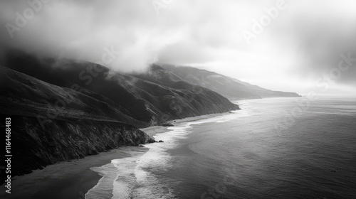 Dramatic black and white coastline of Big Sur with misty mountains and tranquil ocean waves creating a serene coastal landscape