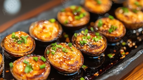 Savory Baked Clams Topped with Soy Sauce and Garnished with Fresh Green Onions photo