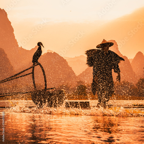 silhouette of a cormorant fisherman at sunsset