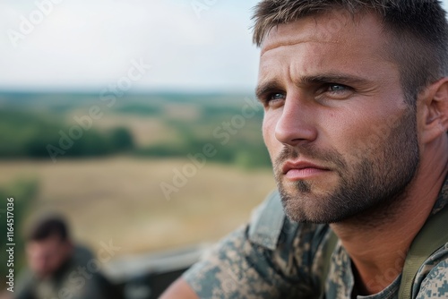 A contemplative Ukrainian soldier gazes into the distance, reflecting on the warfront landscape that surrounds him, highlighting the emotional weight of his service. photo