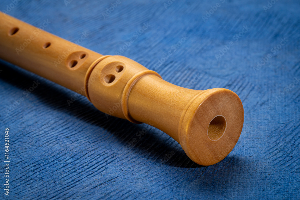 Naklejka premium foot of wooden recorder flute instrument, classic German style, against art paper