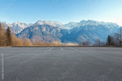 Stunning mountain landscape with an empty parking lot under clear blue sky