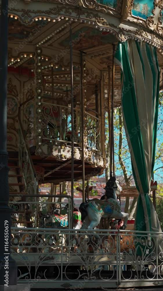 colorful golden carousel spinning with happy kids, cheerful children at antique roundabout at amusement park, vertical video footage