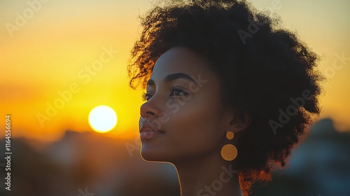 Woman enjoying a sunset on a rooftop with vibrant colors in the background