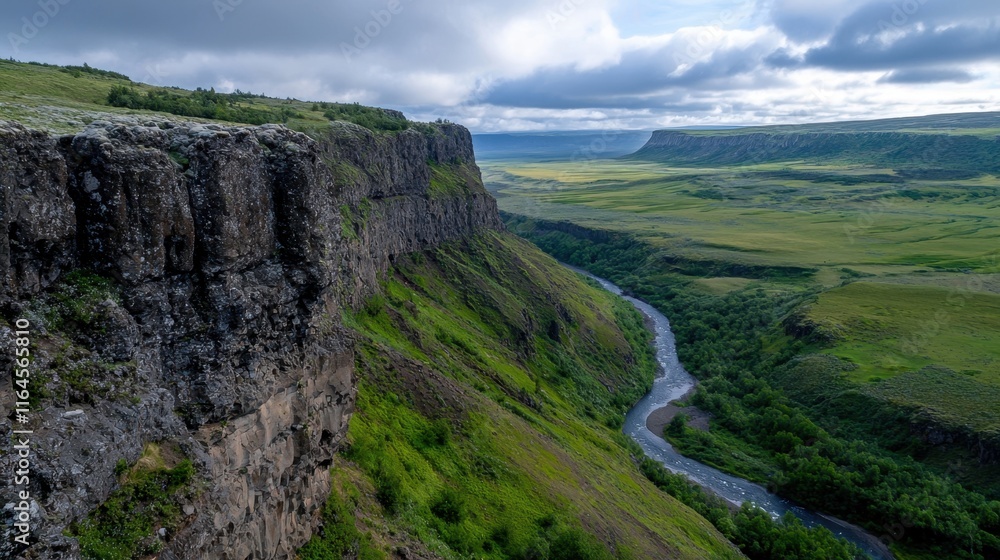Fototapeta premium A mountain range with a river running through it
