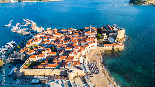 Budva, one of Montenegro's most popular coastal destinations, captured from the drone, offers a breathtaking aerial view of its historic Old Town, sandy beaches, and sparkling Adriatic Sea photo